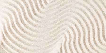 Sand pattern as background. Zen pattern in white sand. Beach san
